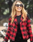 smiling woman with sunglasses wearing red and black flannel-style women's jacket from moto girl