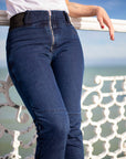 close up of woman's waist wearing blue moto jeans