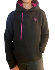 A woman wearing black Moto Girl helmet hoodie with pink details and front zipper