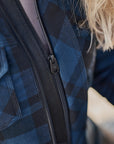 Close-up of a person wearing a blue plaid MOTORCYCLE jacket from Shima with a zipper