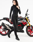 Women starting in front of motorcycle wearing Rebel waterproof motorcycle sneakers from Shima