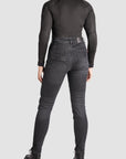 a woman back wearing black jeans and black motorcycle body suit from Pando Moto