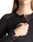 close up of a woman unzipping her black motorcycle body suit from Pando Moto