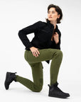 a young woman kneeing and wearing slim fit khaki green lady motorcycle jeans