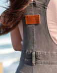A close up of the Moto Girl patch on the back of women's motorcycle overall