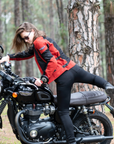 a young woman getting on a Triumph motorcycle wearing red and black women's motorcycle summer jacket from Moto Girl