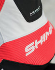 A close up of a woman's back wearing Women's racing suit MIURA RS in black, white and fluo from Shima