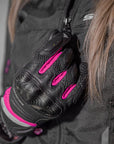 A close up of a woman's hand wearing Black and pink women's motorcycle gloves Rush lady from Shima