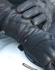 Women hands wearing Long leather black women's motorcycle glove