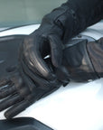 Woman's hands on the motorcycle wearing Long leather black women's motorcycle glove