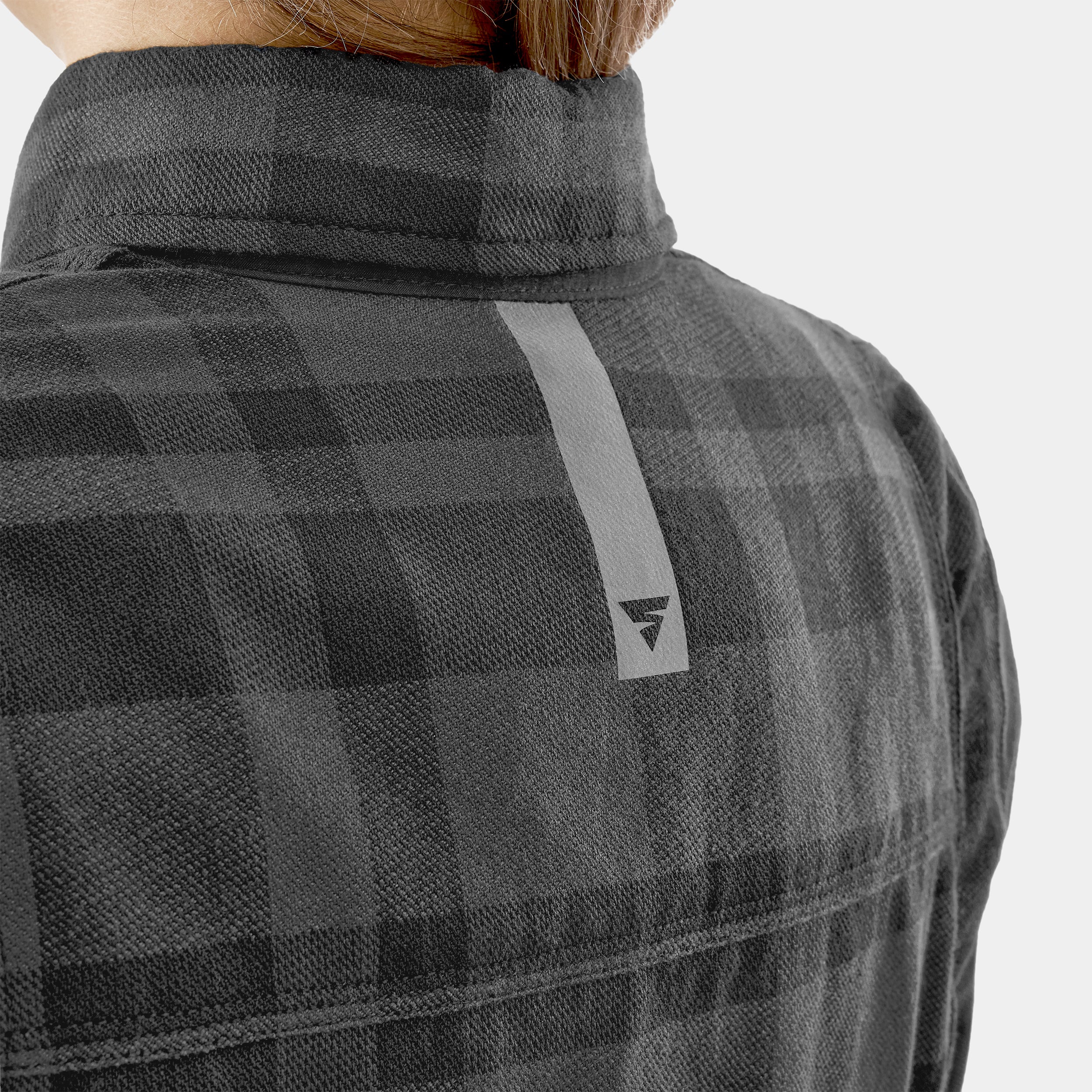 Person wearing a gray checkered jacket with a brand logo on a light gray background
