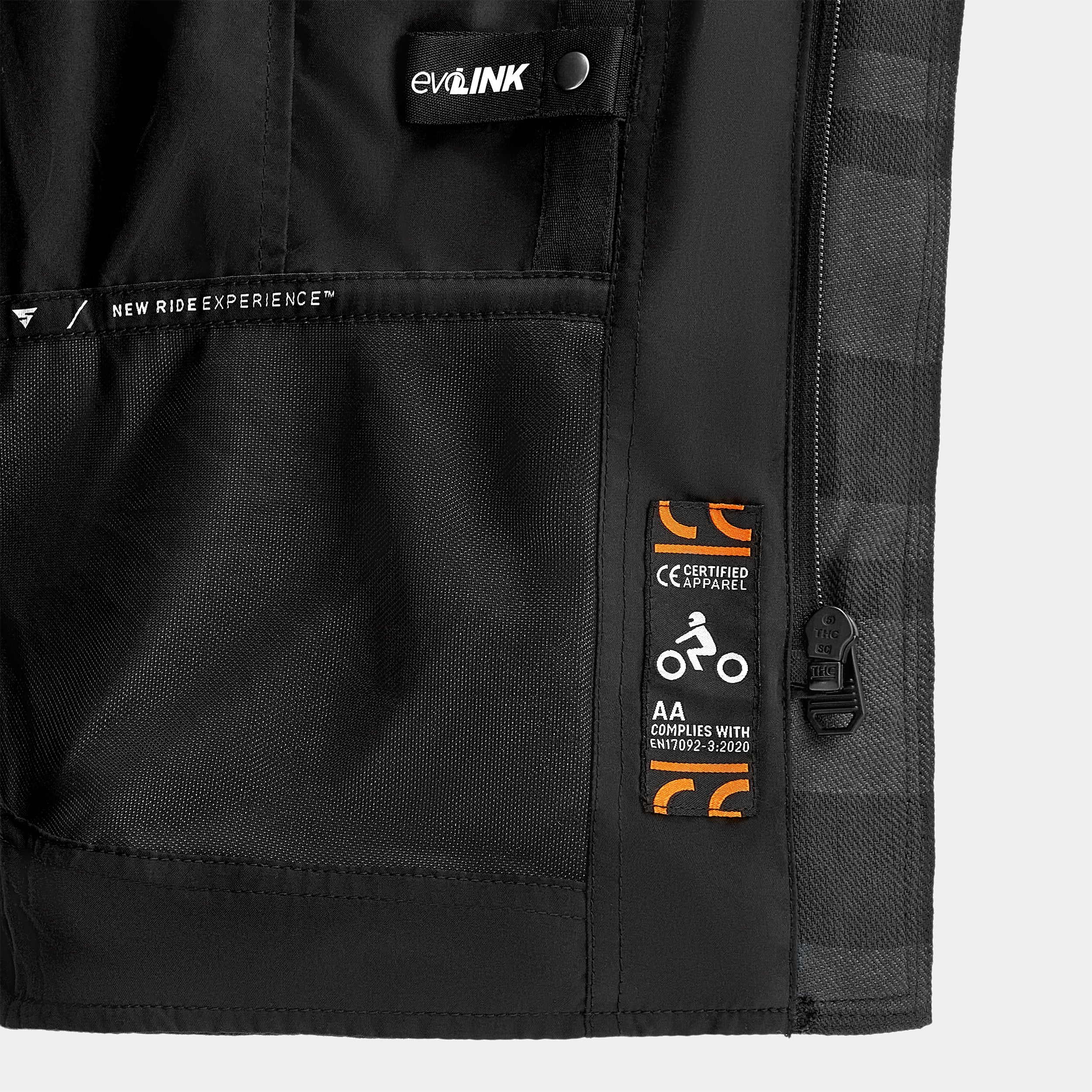 Close-up of a black jacket with visible branding and labels on a gray background