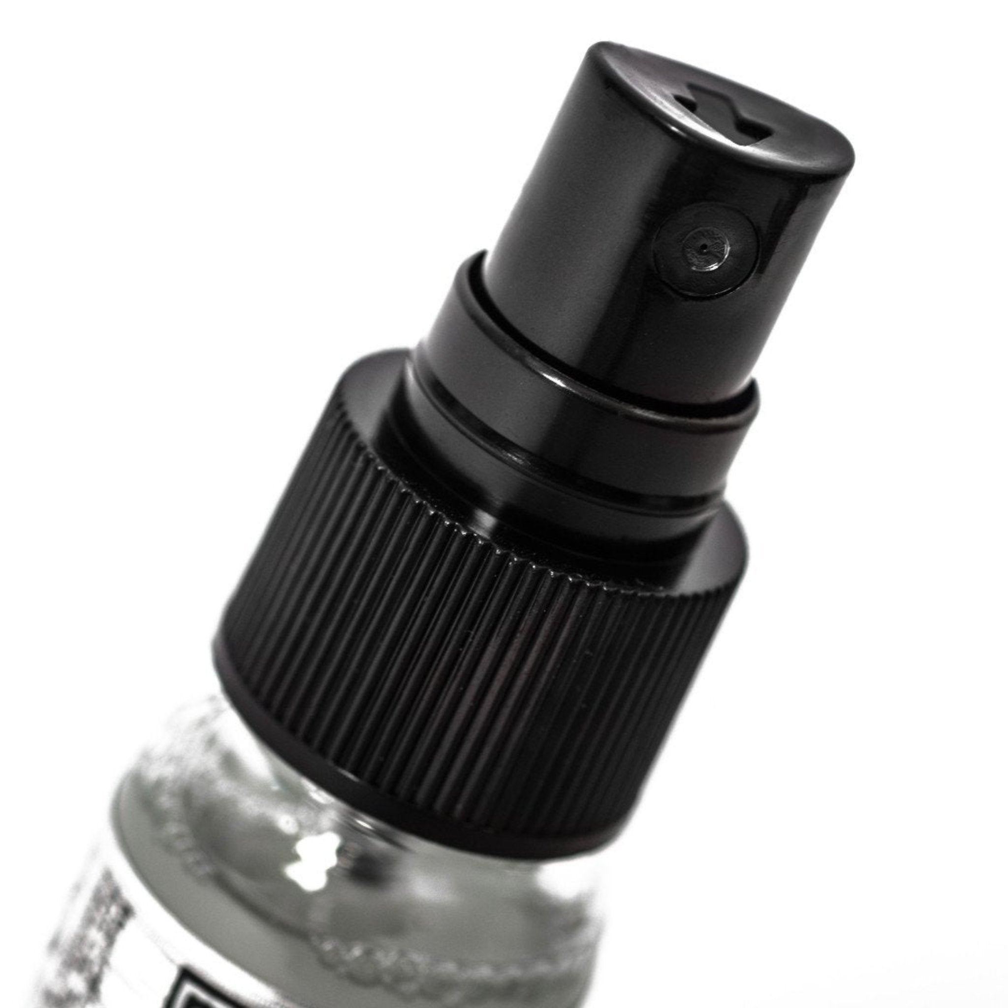 Close-up of Muc-Off Anti-Fog Treatment bottle with a black spray pump top.