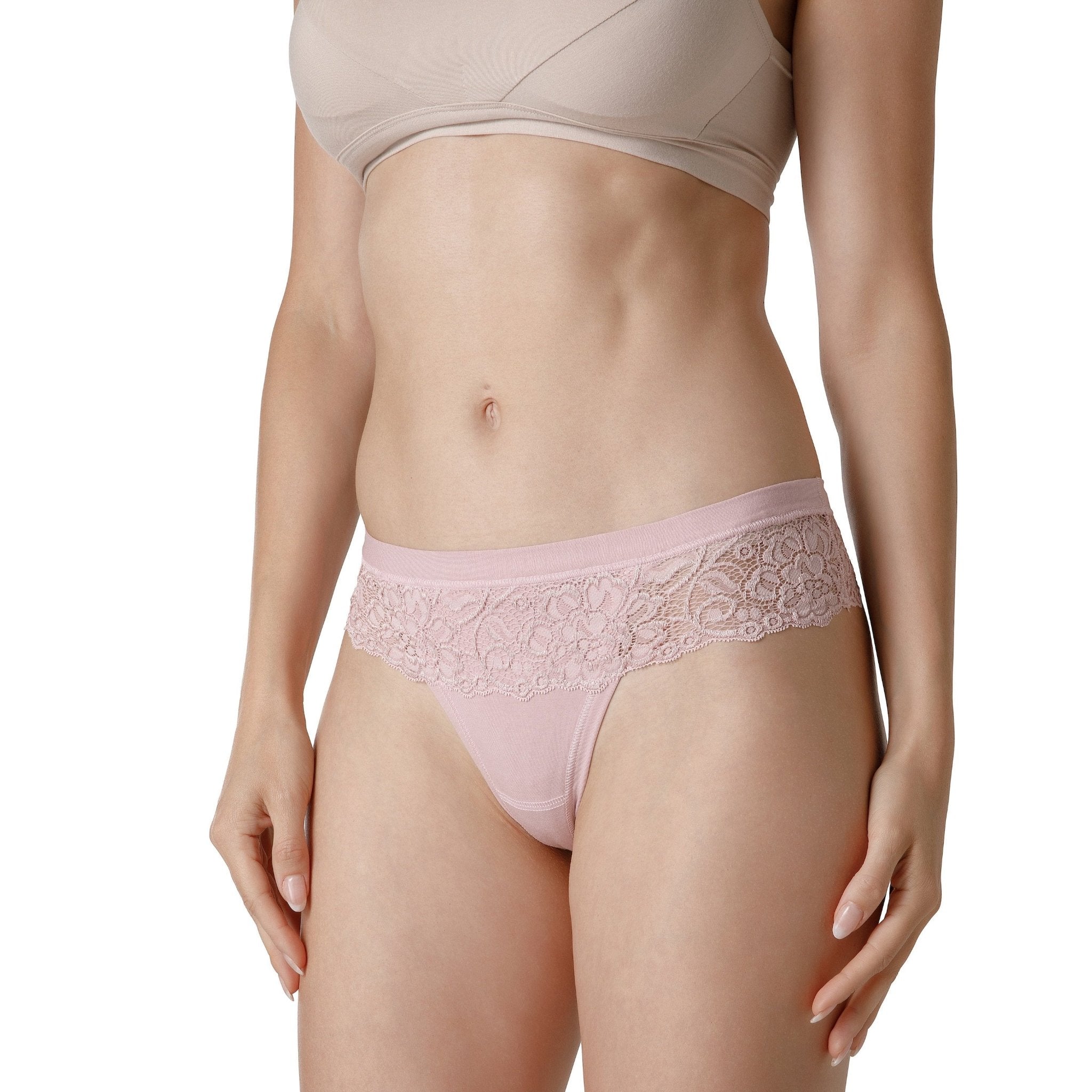 Women wearing nude-colored thongs with lace waistband details from Tramonte.