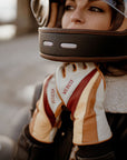 a woman closing her motorcycle helmet wearing colourful leather motorcycle lady gloves from Wildust