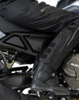 Woman's leg while she sits on her Suzuki motorcycle wearing Shima textile pants