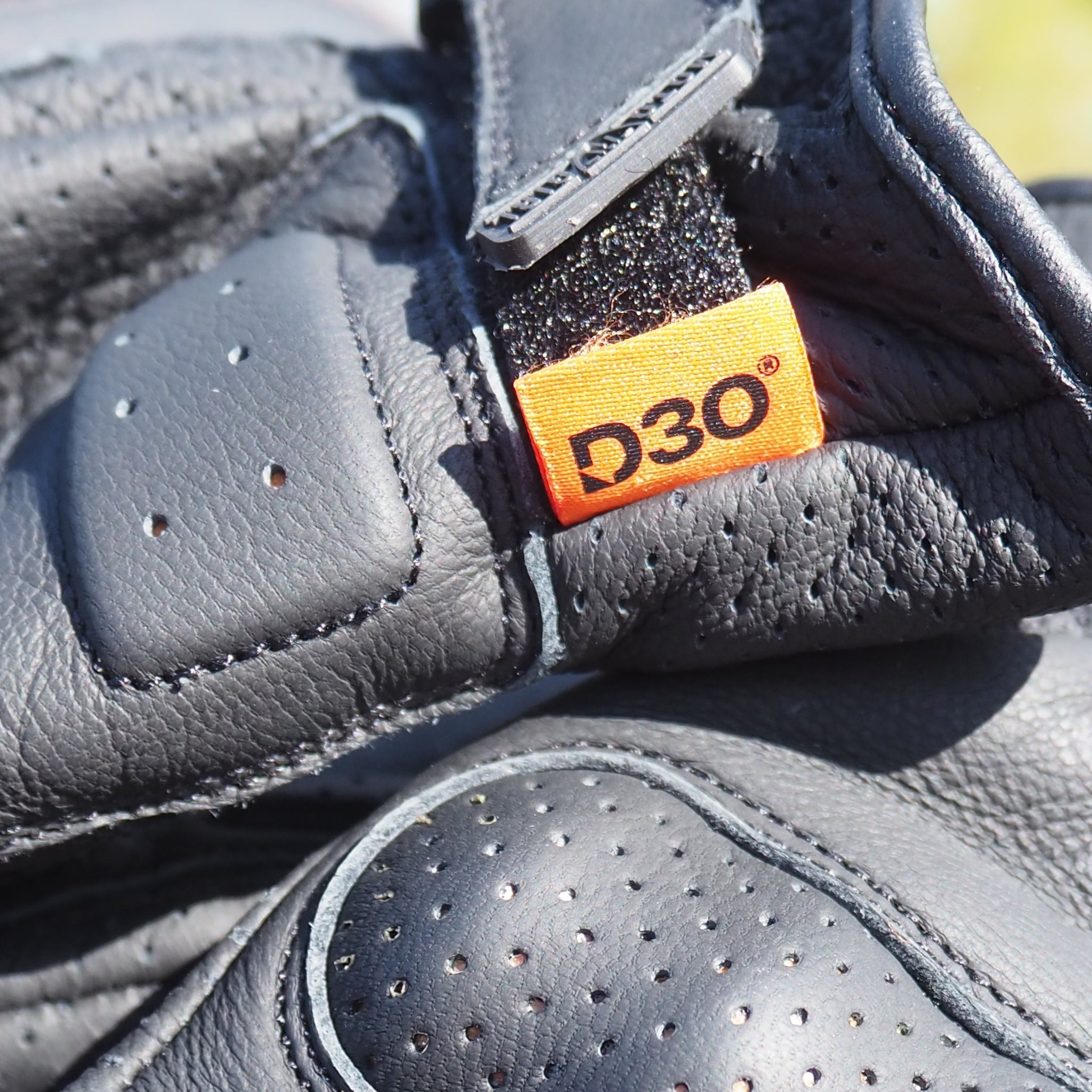 Close-up of a gray shoe with a D3O label on a blurred background