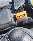 Close-up of a gray shoe with a D3O label on a blurred background