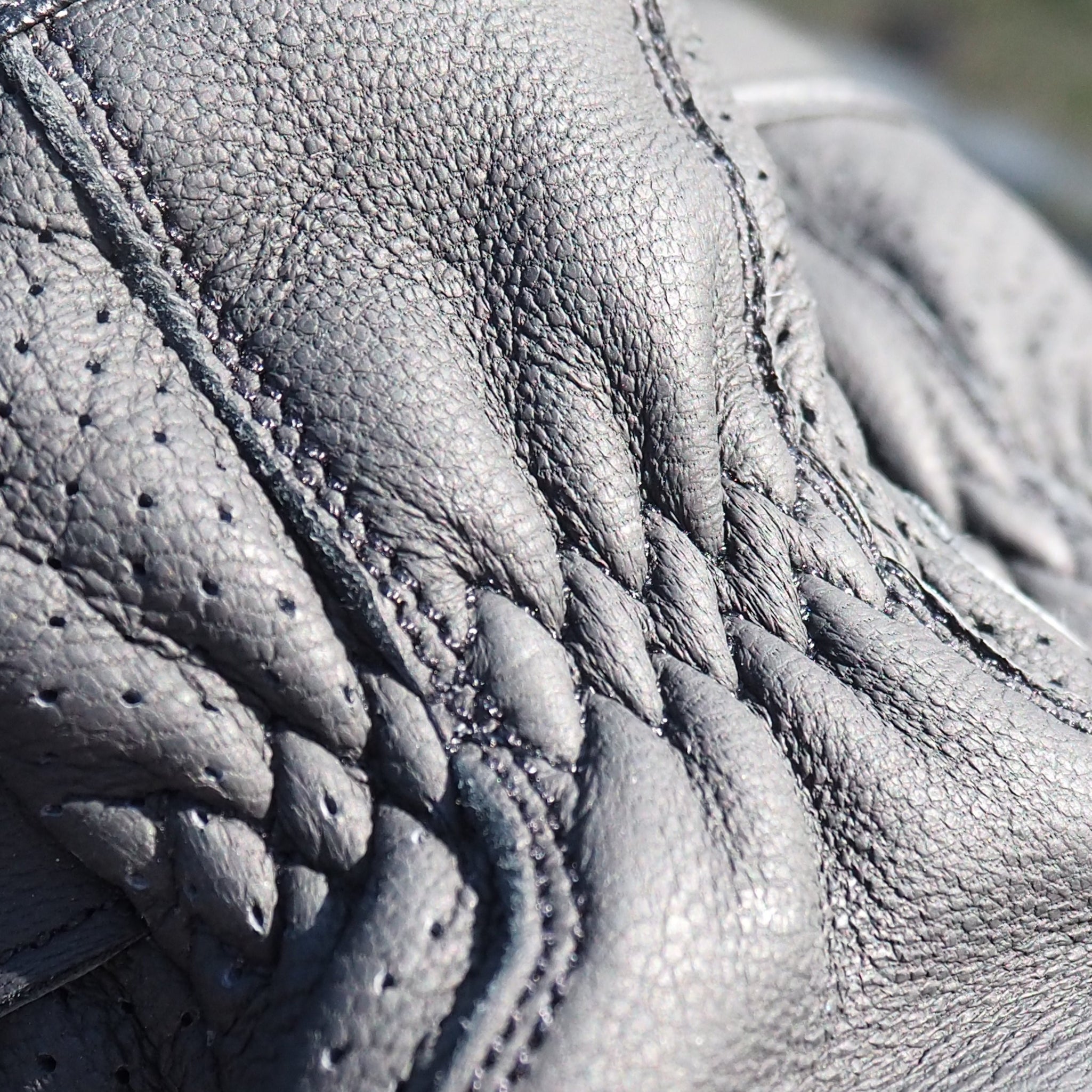 Close-up of a black leather boot with detailed stitching