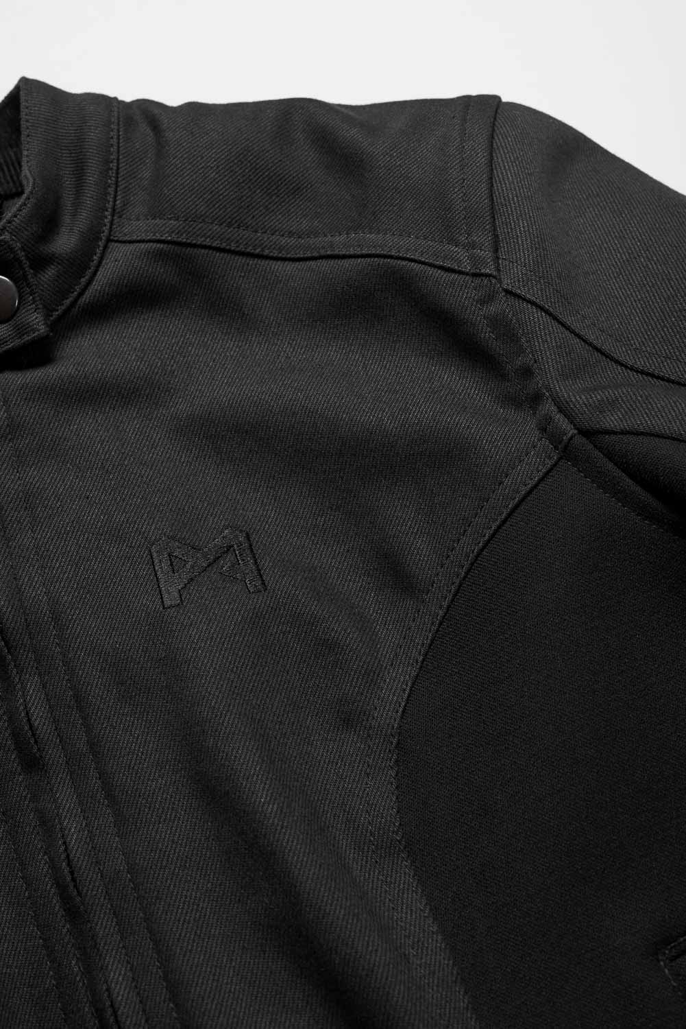 Close-up of a black jacket with a logo on a white background