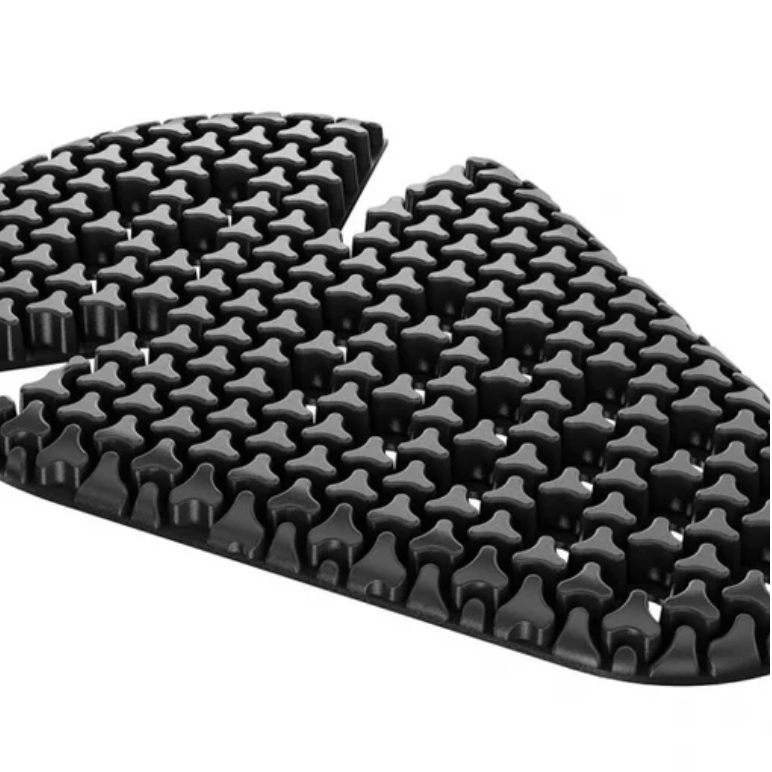 A black textured rubber or foam pad with a repeating star-like raised pattern, shown on a plain white background.
