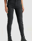 woman's legs wearing black high waist motorcycle jeans