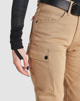 A close-up of the cargo pocket on the beige women's MC pants from the side.