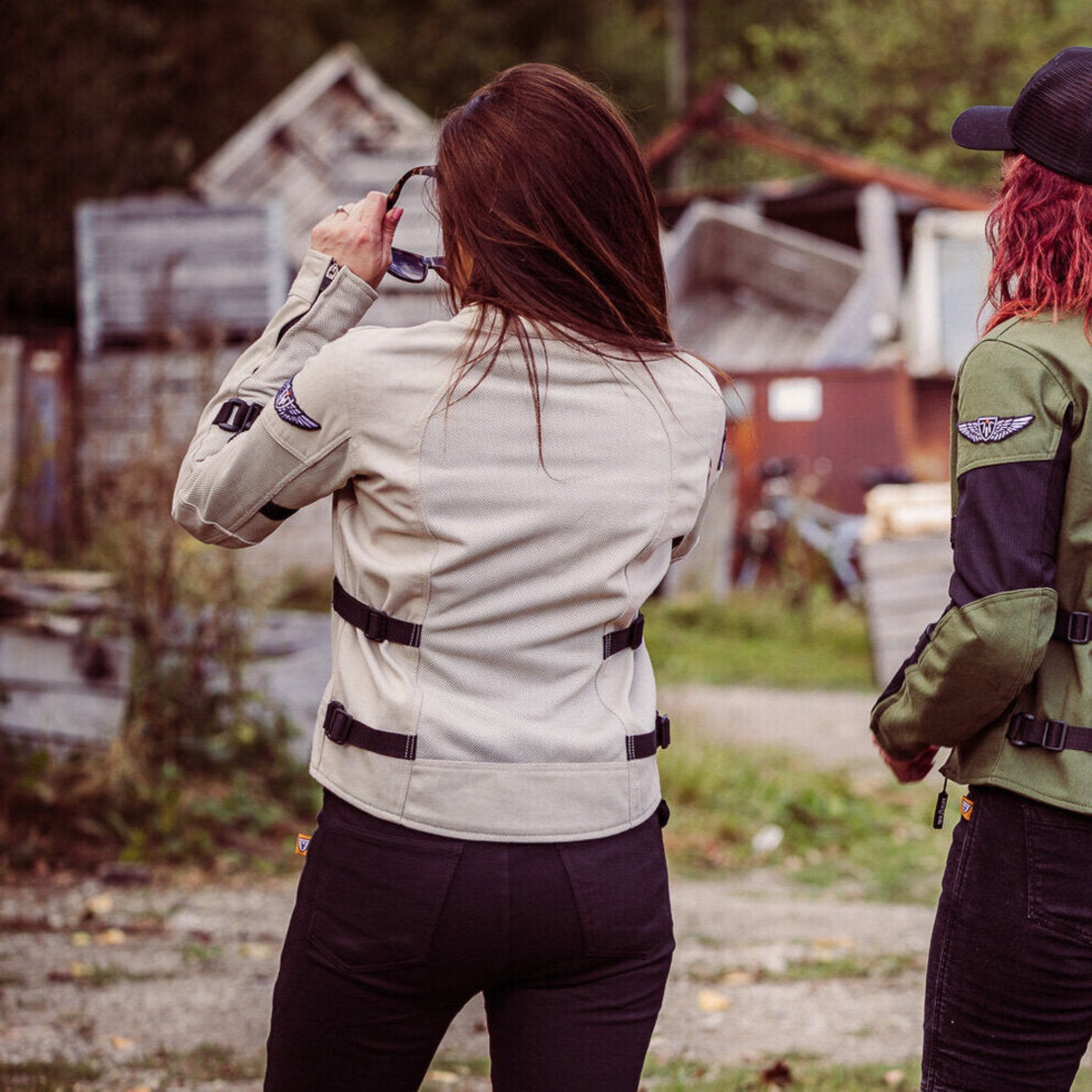 a back of a woman putting sunglasses on and wearing light color women's summer mesh motorcycle jacket from Moto Girl 