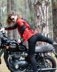 a young woman getting on a Triumph motorcycle wearing red and black women's motorcycle summer jacket from Moto Girl 