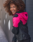 A smiling woman wearing pink DRIFT  motorcycle jacket from Shima