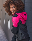 A young afroamerican woman wearing pink motorcycle jacket with the hood 