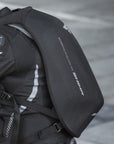 A person's back wearing black motorcycle backpack 