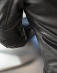 A close up of a sleeve of women's leather motorcycle jacket