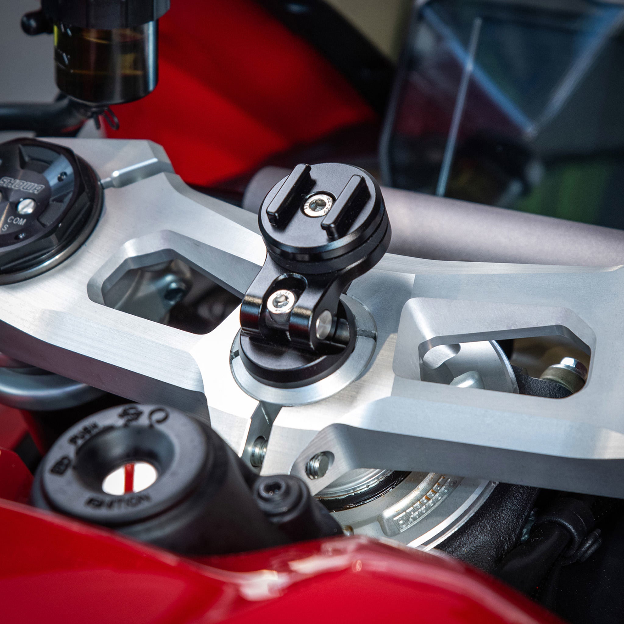 a black SP MOTO STEM MOUNT mounted on the red motorcycle