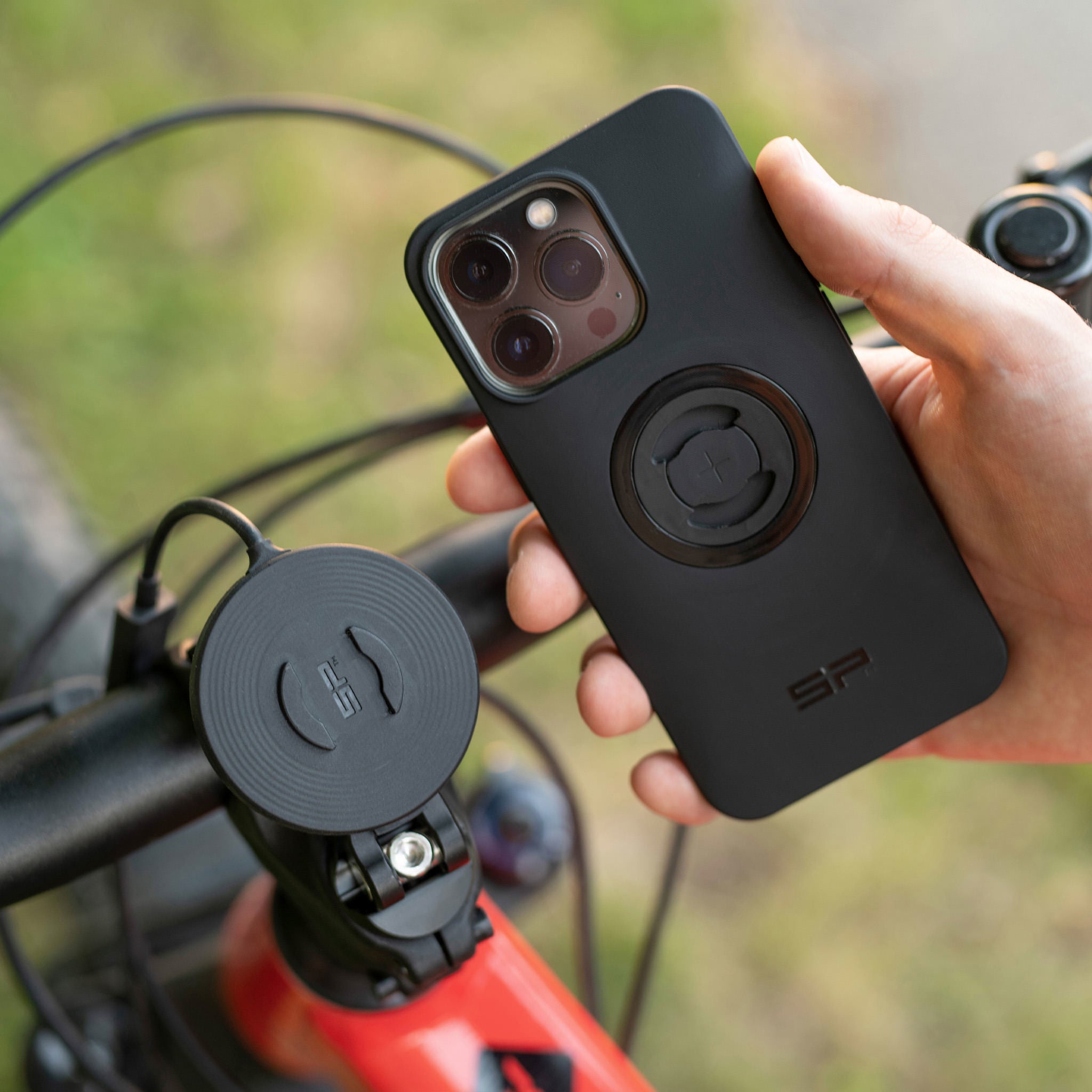 A phone and its holder mounted on a motorcycle 