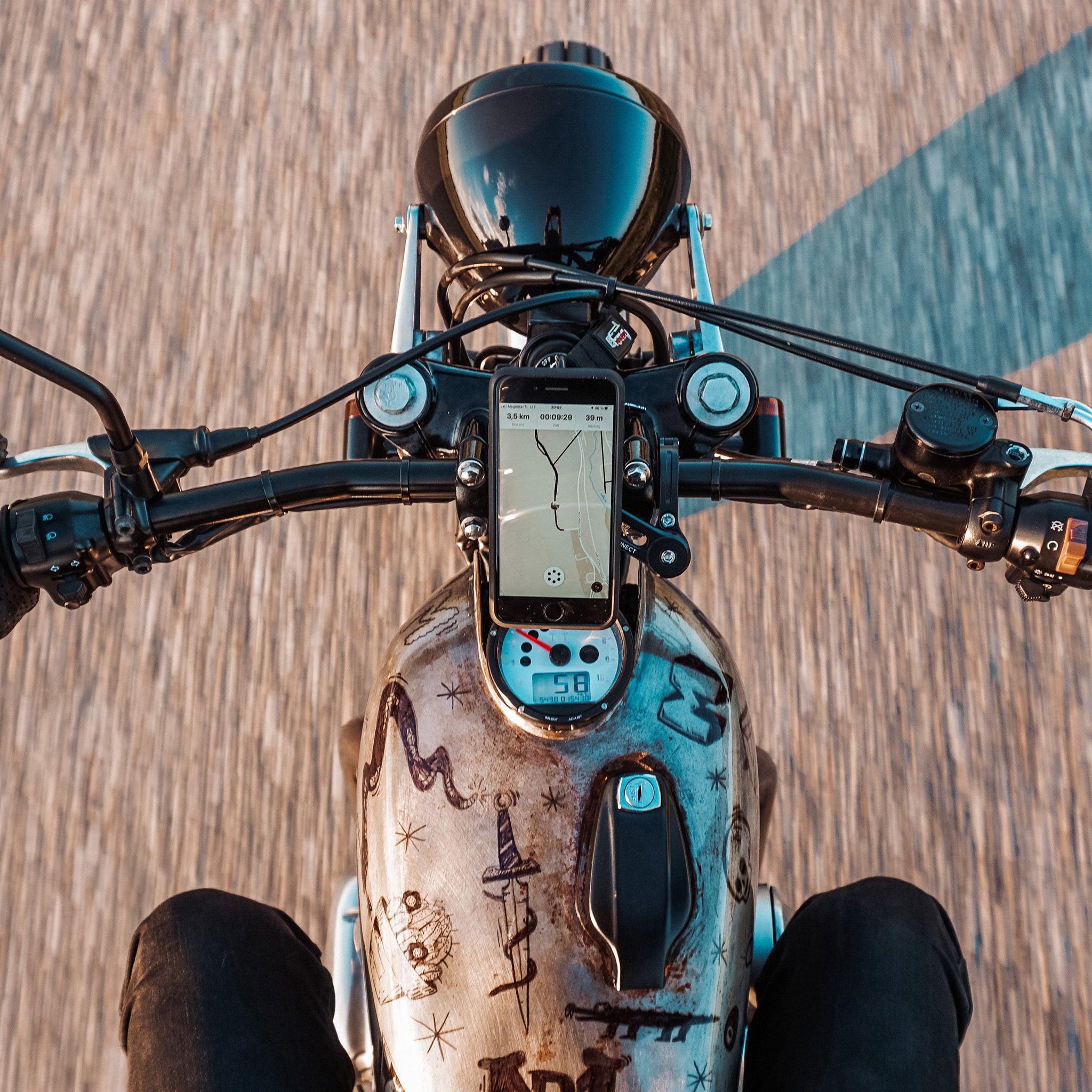 A phone mounted on the motorcycle handlebar