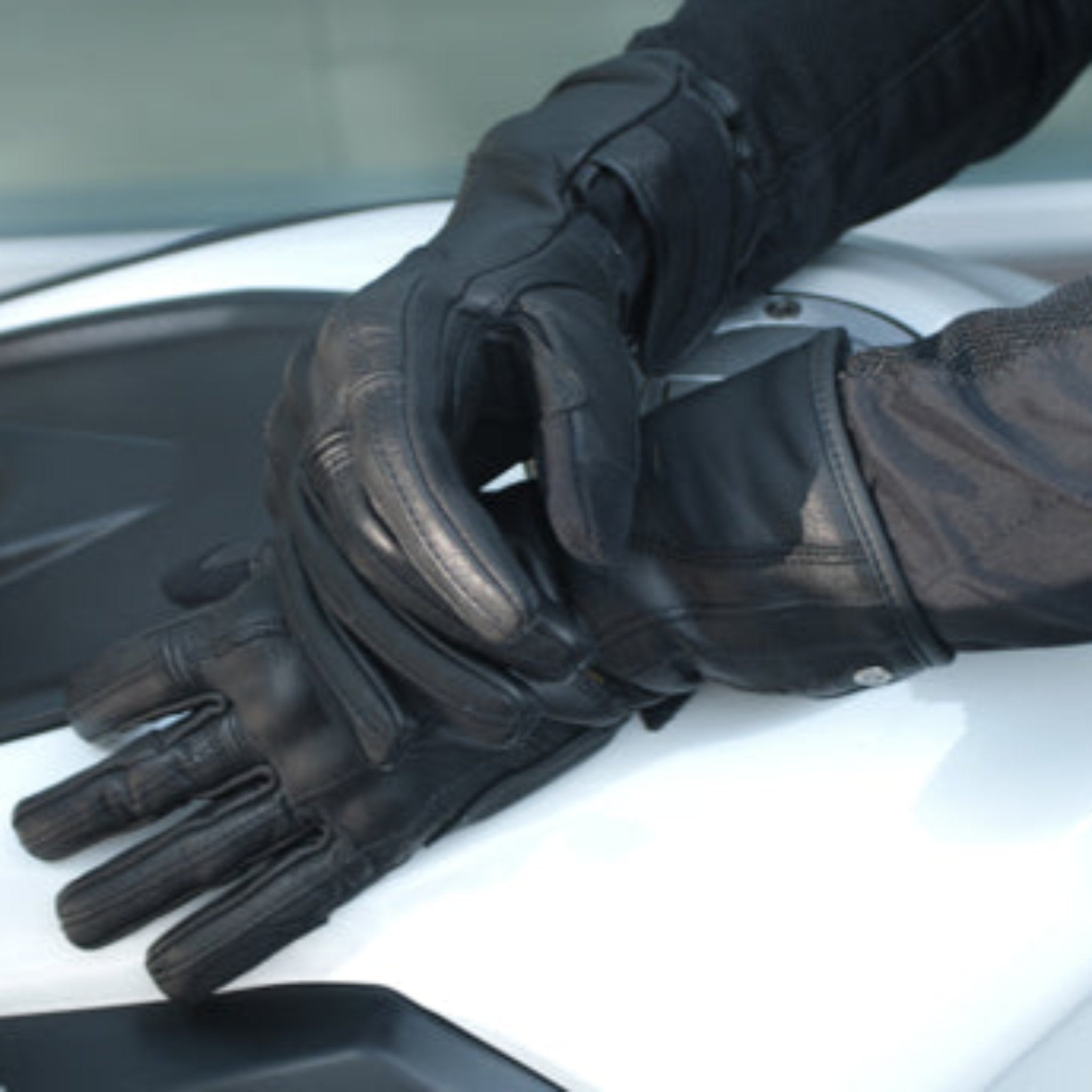 Woman's hands on the motorcycle wearing Long leather black women's motorcycle glove